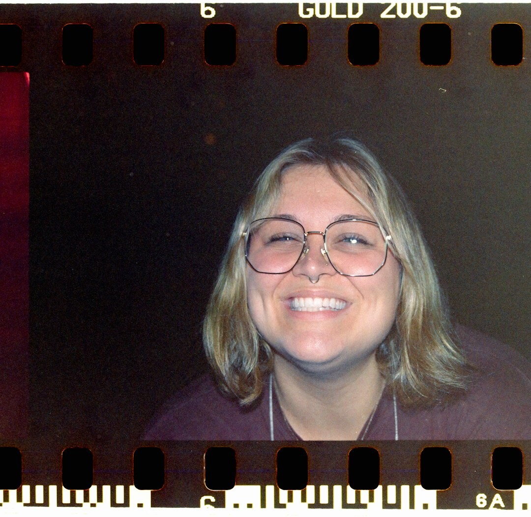Studio portrait of a woman with glasses, broadcast coordinator
