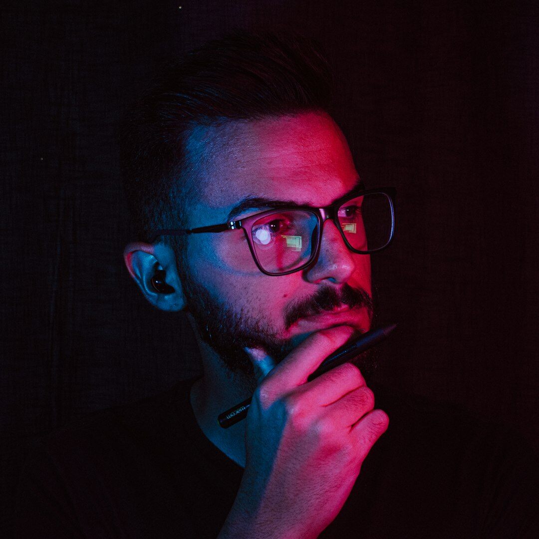 Studio portrait of a man with beard and glasses, content strategist