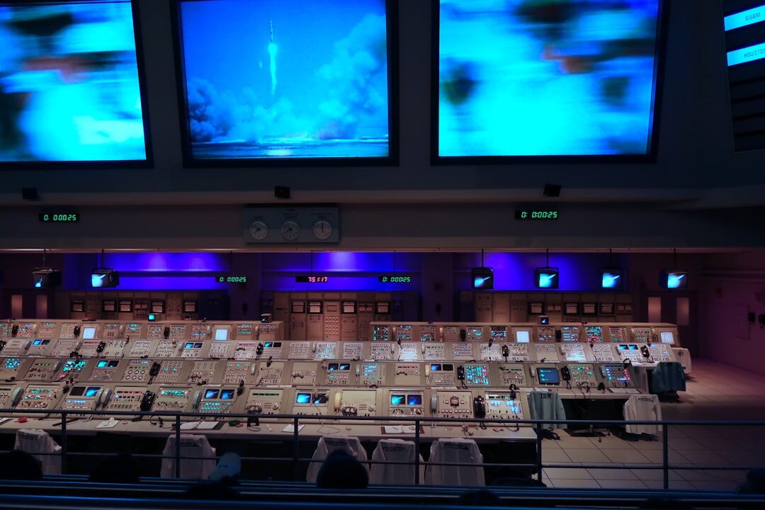 Newsroom control room with multiple screens showing breaking news alerts