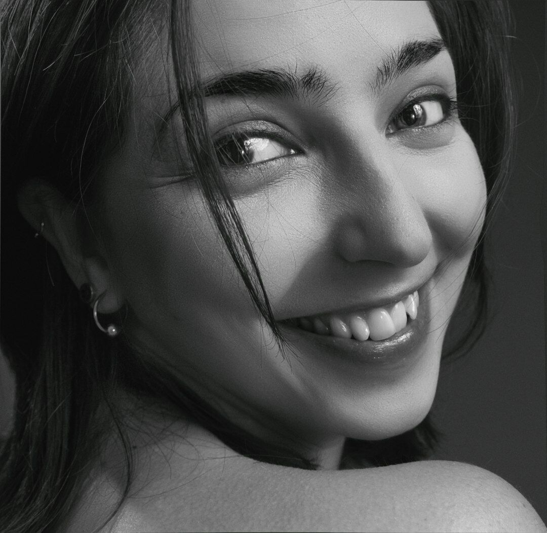 Studio portrait of a smiling woman, technical producer