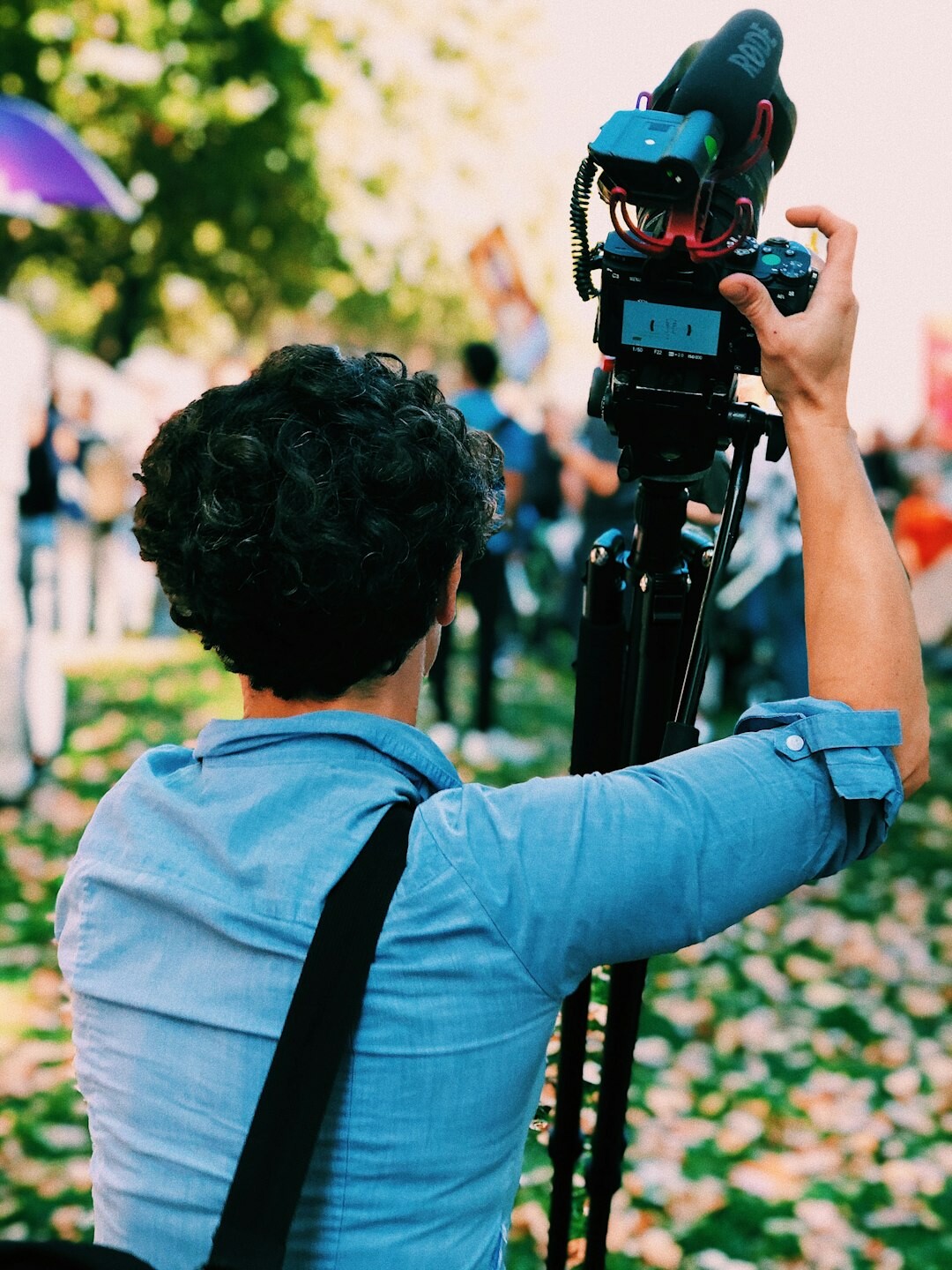 Belgian television reporter delivering a live news report outdoors with a microphone