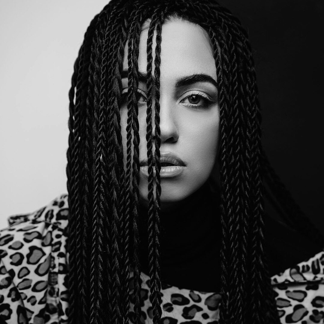 Studio portrait of a woman with braids, social and alert editor